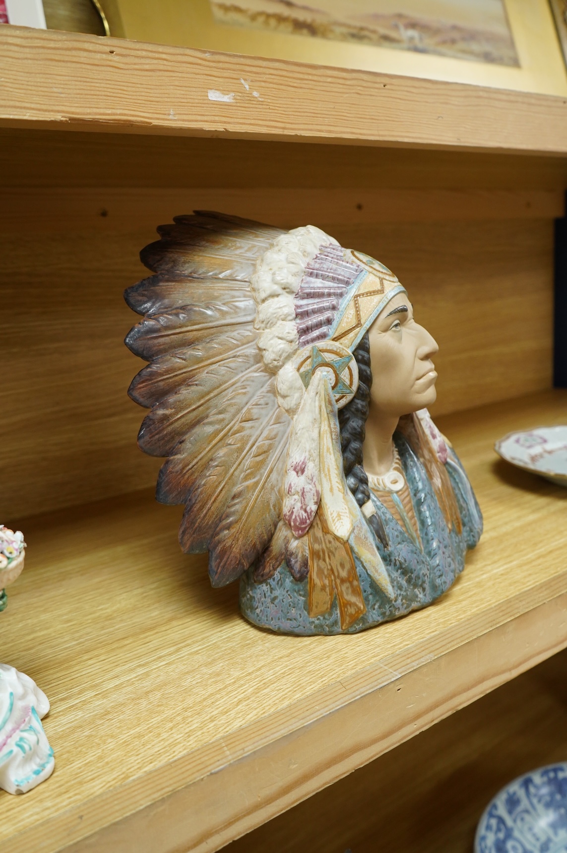 A Lladro bust of a native America chief with feather tribal headdress, 29cm high. (Bust on stand)